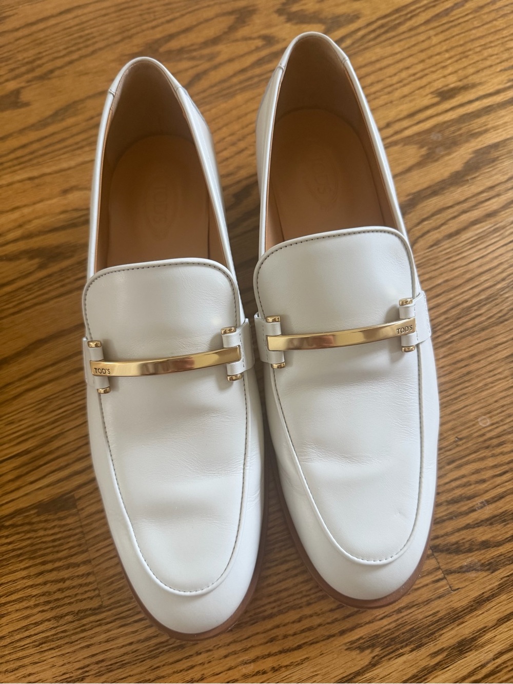 Tod's White Leather Slip-On Loafers with Gold Bar
